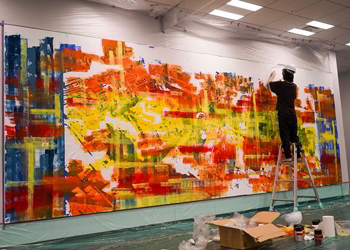 Photo of Ms. Kotori Nakamura while creating the mural