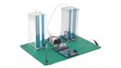 Angled view of the capacitive touch liquid level indicator reference design with two transparent tanks, connecting tubes, sensors, and a CPU board and control board.