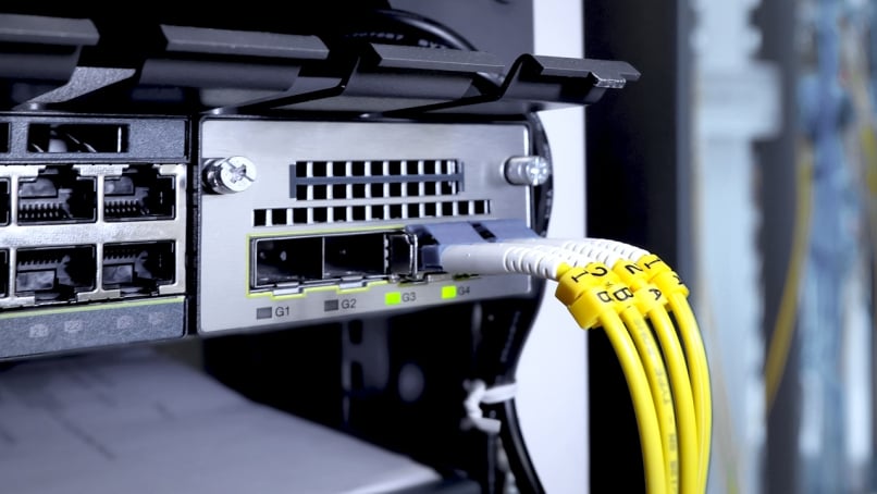 Fiber optic cable and high speed network router switch in a technology data center room.